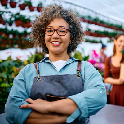 A confident female business owner who has sold her company to fund a comfortable retirement through expert coordination.